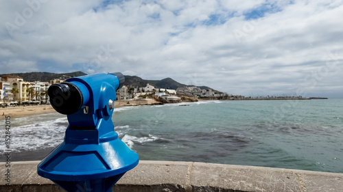 Photography A coin-operated public telescope overlooking a serene Mediterranean coastline, i