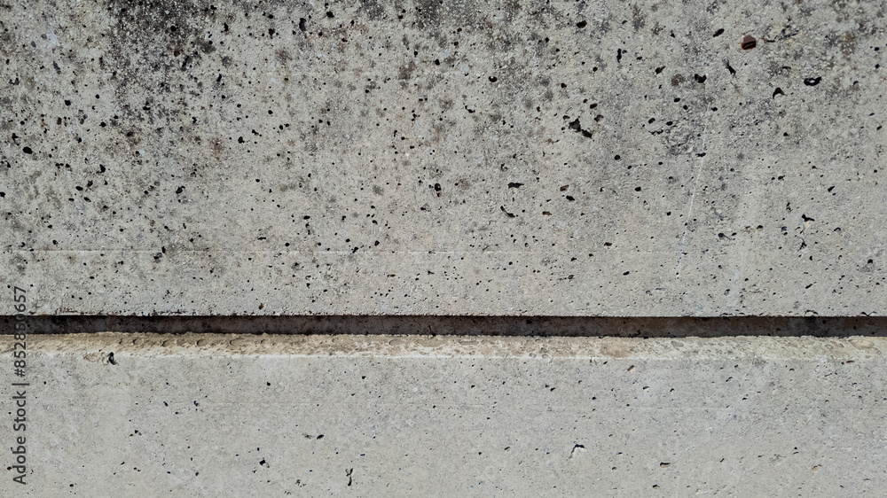 Concrete wall with visible seam, detailed gray texture perfect for construction backgrounds and industrial design projects