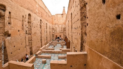 A group of tourists wandering inside El Badi Palace in Marrakesh, Morocco - June 1, 2024 photo