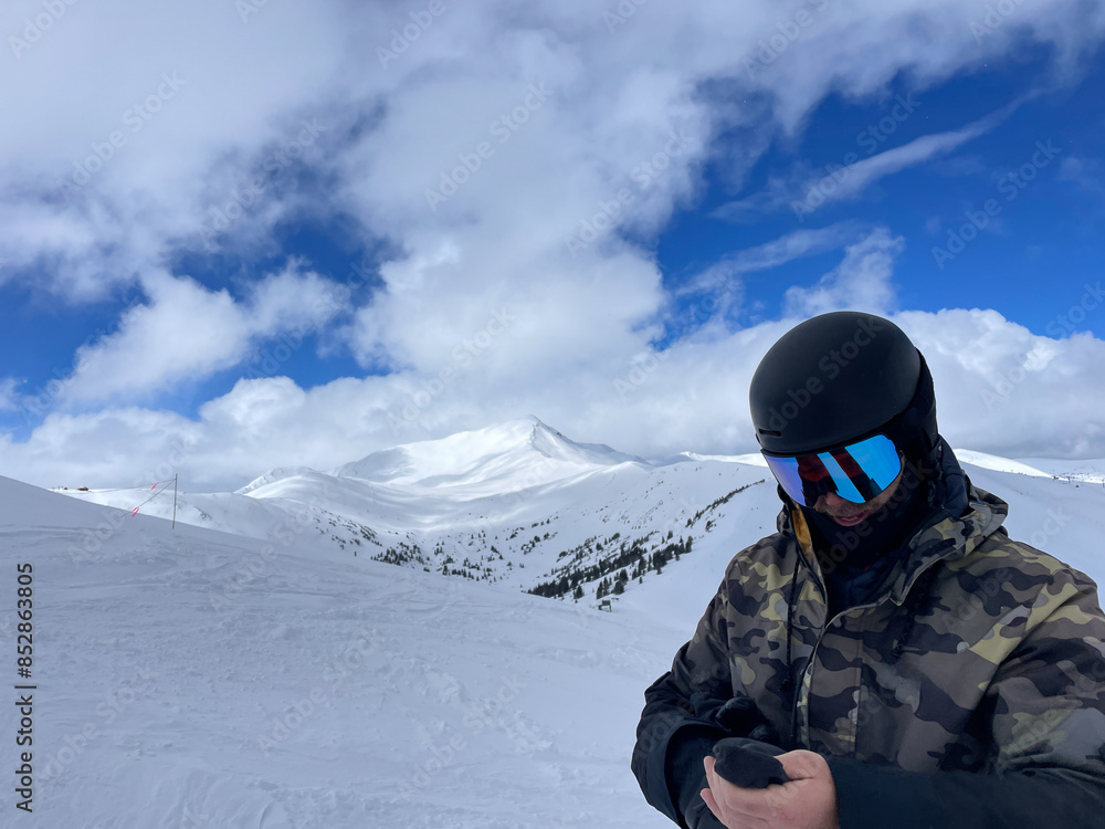 Man on snowboard overlooking Copper mountain Man on snowboard overlooking Copper mountain