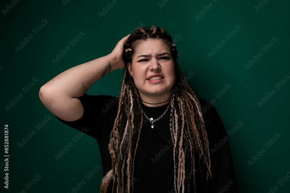 Woman With Dreadlocks Standing in Front of Green Wall Woman With Dreadlocks Standing in Front of Green Wall