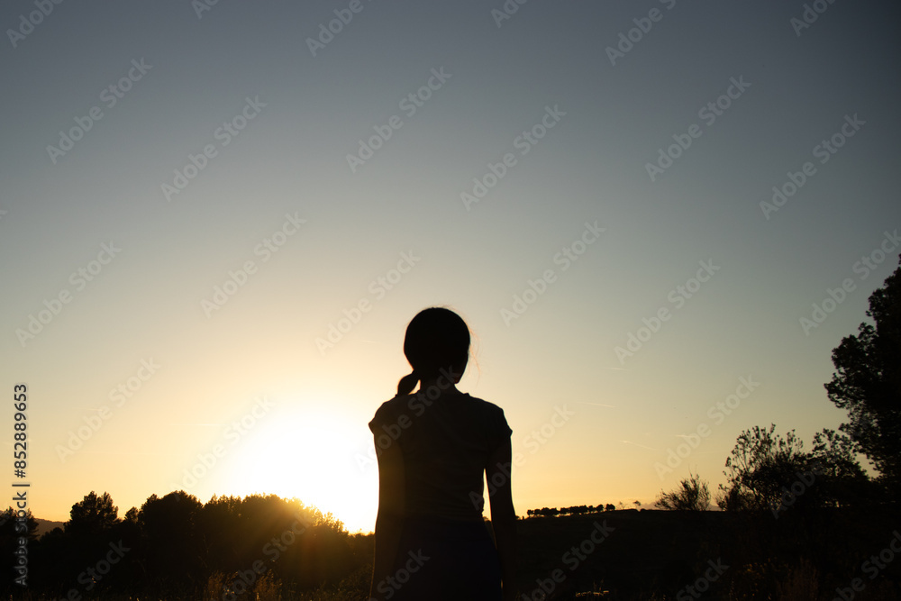 Silhouette of a beautiful young female on a summer walk in nature during golden hour in the spanish village El Papiol, near Barcelona, Spain Silhouette of a beautiful young female on a summer walk in nature during golden hour in the spanish village El Papiol, near Barcelona, Spain