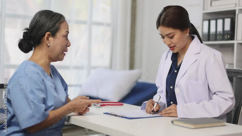 Female doctor talking with senior female patient in examination room at hospital. Health consultants from specialist doctors at hospital clinics. Female doctor talking with senior female patient in examination room at hospital. Health consultants from specialist doctors at hospital clinics.