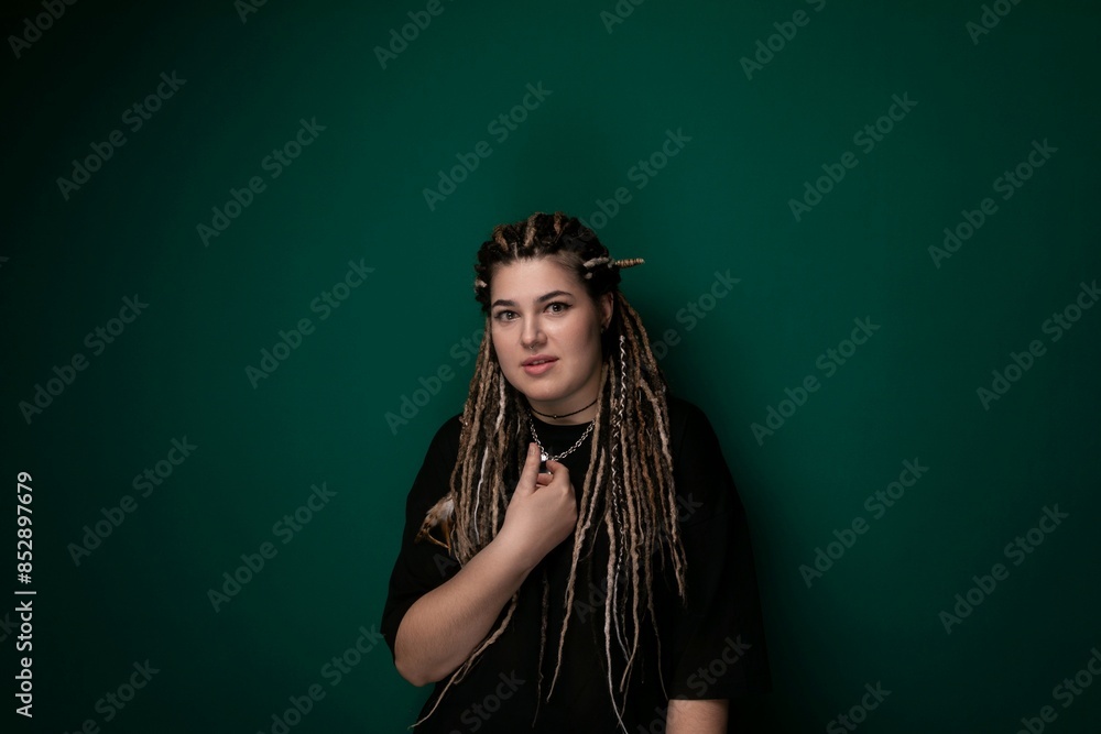 Woman With Dreadlocks Standing in Front of Green Wall Woman With Dreadlocks Standing in Front of Green Wall