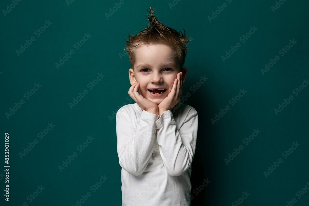 Little Boy Standing in Front of Green Wall Little Boy Standing in Front of Green Wall