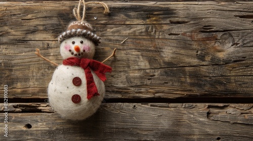 Felt snowman Christmas ornament with vintage flair on rustic wood backdrop for customized message photo