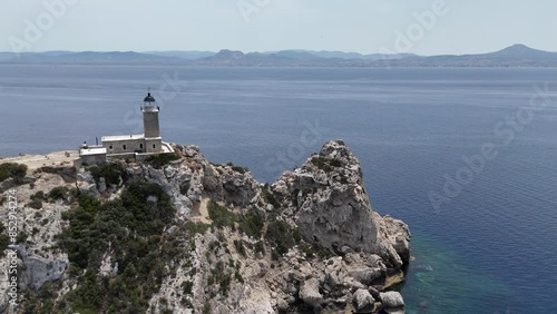 Aerial drone photo of beautiful and picturesque cape Melagavi forming a small peninsula with unique lighthouse stand out next to archaeological site of Heraion, Loutraki, Greece photo