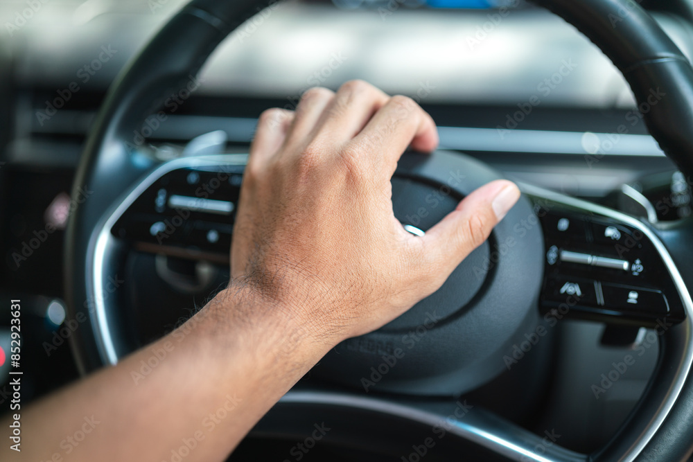 Action of the driver's hand is beeping or pushing the horn on car steering wheel. Close-up. Action of the driver's hand is beeping or pushing the horn on car steering wheel. Close-up.
