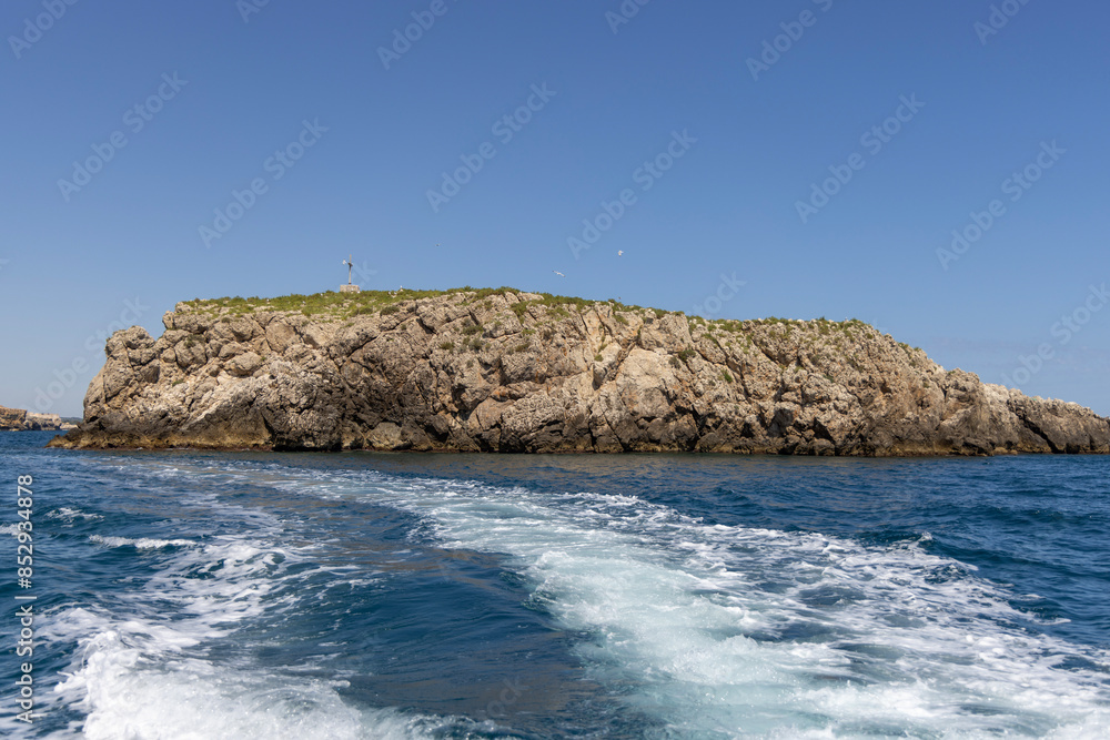 View from the water of picturesque coastline with cliffs and caves by Adriatic Sea, Polignano a Mare, Italy, Apulia