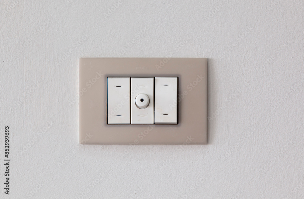 European style wall light switch on a white background. Three sections and dimmer control. Space for copying European style wall light switch on a white background. Three sections and dimmer control. Space for copying
