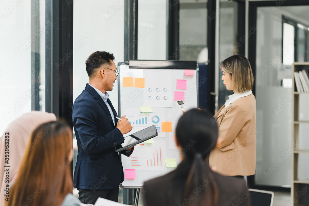Diverse business team analyzing data and discussing strategies during an office meeting, using documents and a laptop. Diverse business team analyzing data and discussing strategies during an office meeting, using documents and a laptop.