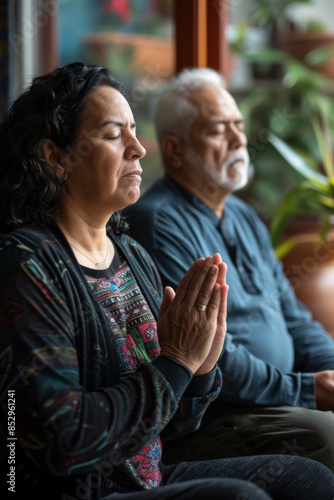 a Hispanic couple engaging in a morning prayer or meditation session together