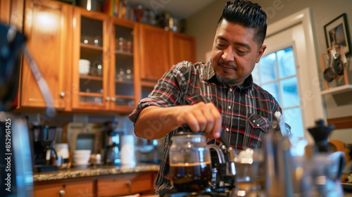 a Hispanic man preparing his favorite coffee brew with a French press in his kitchen © wolfhound911