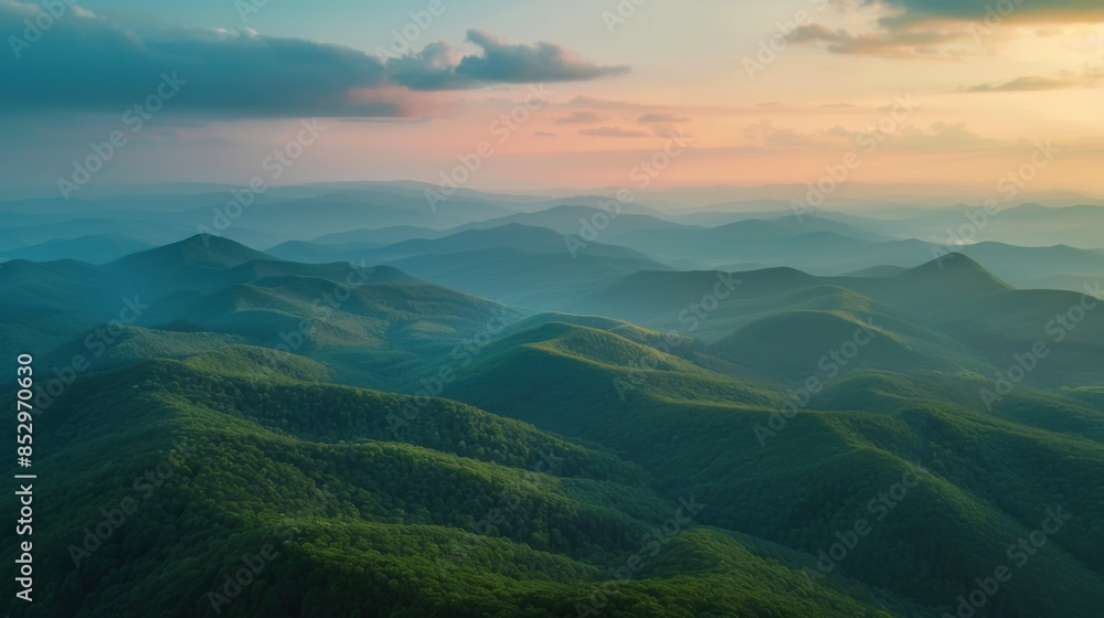 photo of green mountains from above in warm colors at sunrise. photo of green mountains from above in warm colors at sunrise.