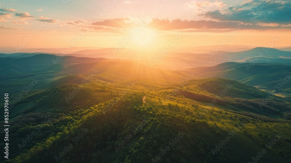 photo of green mountains from above in warm colors at sunrise. photo of green mountains from above in warm colors at sunrise.