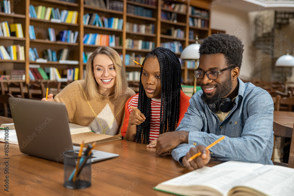 Students studying in the library and looking involved Students studying in the library and looking involved