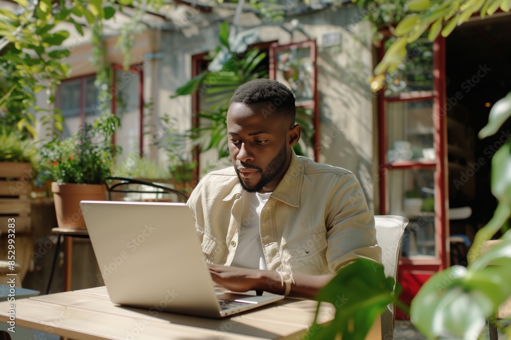 Obraz premium Successful African American Freelancer in Cafe Summer Terrace Video Conference.