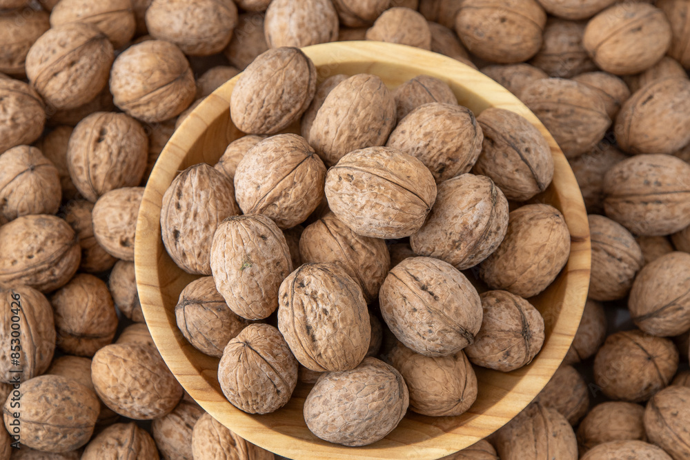Walnut in shell. Background view from above. Healthy food bowl top view Walnut in shell. Background view from above. Healthy food bowl top view
