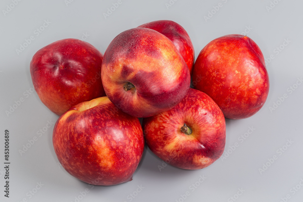 Heap of ripe nectarines on a gray background close-up Heap of ripe nectarines on a gray background close-up
