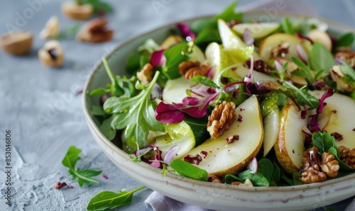 Pear and walnut salad on a light lavender surface