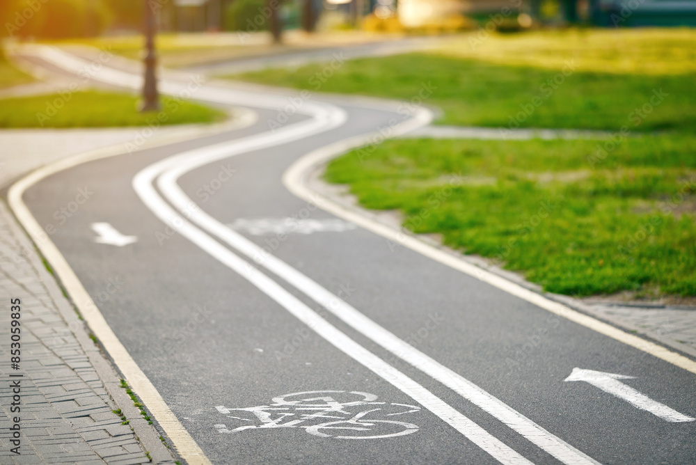Bicycle lane sign, curvy marked bike lane winding through park. Winding bicycle lane in green park.Bicycle lane in park, safe and enjoyable route for cyclists to ride and explore the outdoors