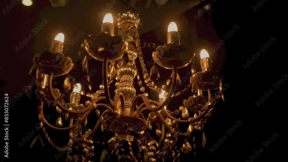 The bokeh of a crystal chandelier with crystals shimmers with bright lights. The bokeh of a crystal chandelier with crystals shimmers with bright lights.