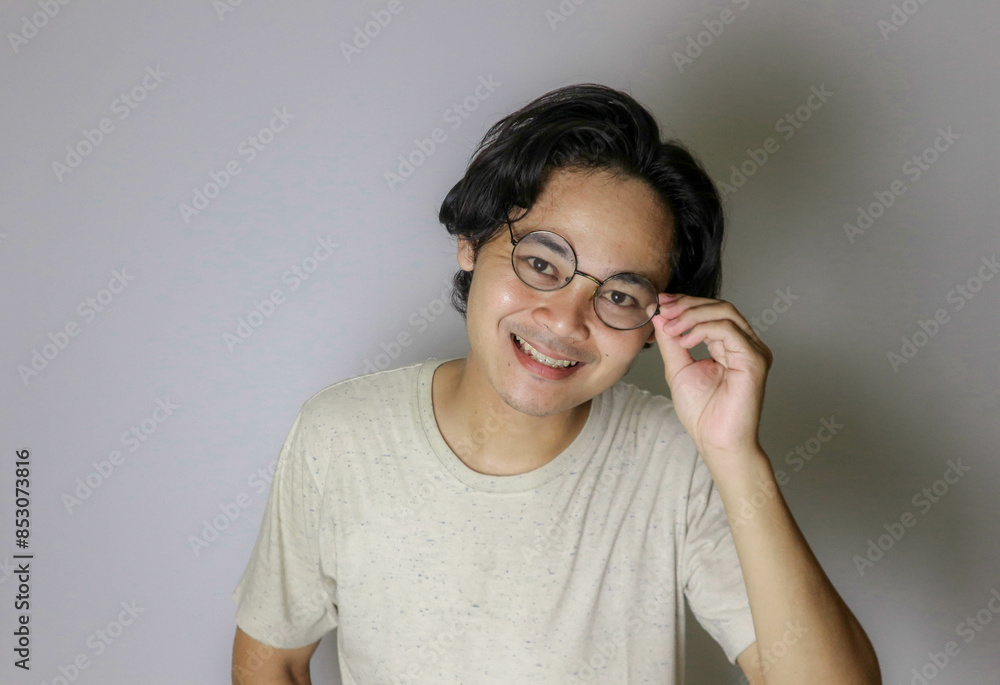 portrait of an Asian Indonesian man posing with random expressions on an isolated white background and white shirt portrait of an Asian Indonesian man posing with random expressions on an isolated white background and white shirt