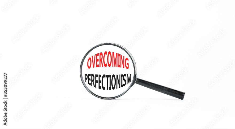 Overcoming perfectionism symbol. Concept words Overcoming perfectionism in beautiful magnifying glass. Beautiful white paper background. Business Overcoming perfectionism concept. Copy space. Overcoming perfectionism symbol. Concept words Overcoming perfectionism in beautiful magnifying glass. Beautiful white paper background. Business Overcoming perfectionism concept. Copy space.
