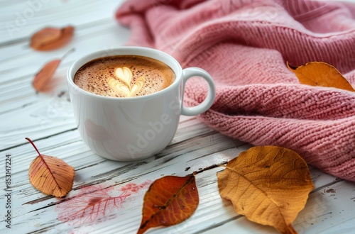 Warm Latte With Autumn Leaves and Blanket on White Wooden Table