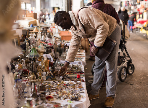 South African man selects antiques at a flea market photo