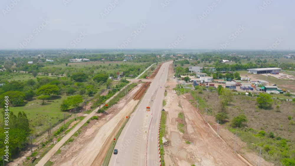 Aerial view of construction tractor car, bulldozer, or backhoe digging road or street in traffic transportation and agriculture concept. Engine working in urban city town. Aerial view of construction tractor car, bulldozer, or backhoe digging road or street in traffic transportation and agriculture concept. Engine working in urban city town.
