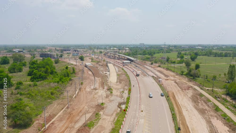Aerial view of construction tractor car, bulldozer, or backhoe digging road or street in traffic transportation and agriculture concept. Engine working in urban city town. Aerial view of construction tractor car, bulldozer, or backhoe digging road or street in traffic transportation and agriculture concept. Engine working in urban city town.