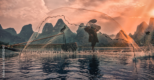 Fotografi silhouette of an old cormorant fisherman on the Li river in China, Guilin