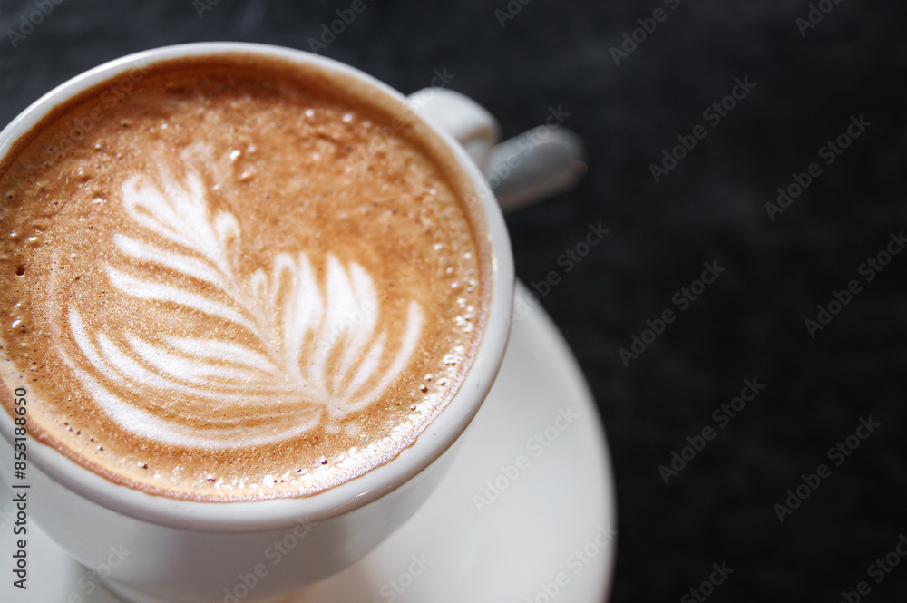 Cup of cappuccino close-up on a black. Latte art Cup of cappuccino close-up on a black. Latte art