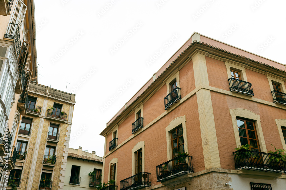 Fototapeta premium A street in the historical old town of Valencia. typical Spanish real estate blocks during a summer day