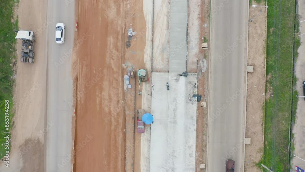Aerial view of construction tractor car, bulldozer, or backhoe digging road or street in traffic transportation and agriculture concept. Engine working in urban city town. Aerial view of construction tractor car, bulldozer, or backhoe digging road or street in traffic transportation and agriculture concept. Engine working in urban city town.
