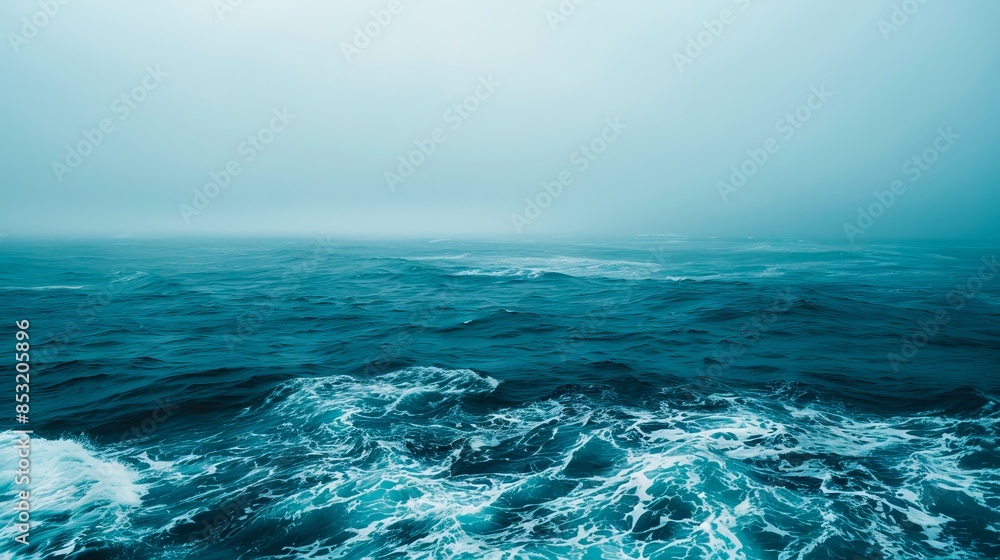 Fototapeta premium A foggy ocean with waves and fog.