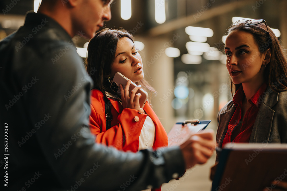 Young corporate business partners engaged in discussion in a modern office environment. Teamwork and collaboration in a professional setting. Young corporate business partners engaged in discussion in a modern office environment. Teamwork and collaboration in a professional setting.