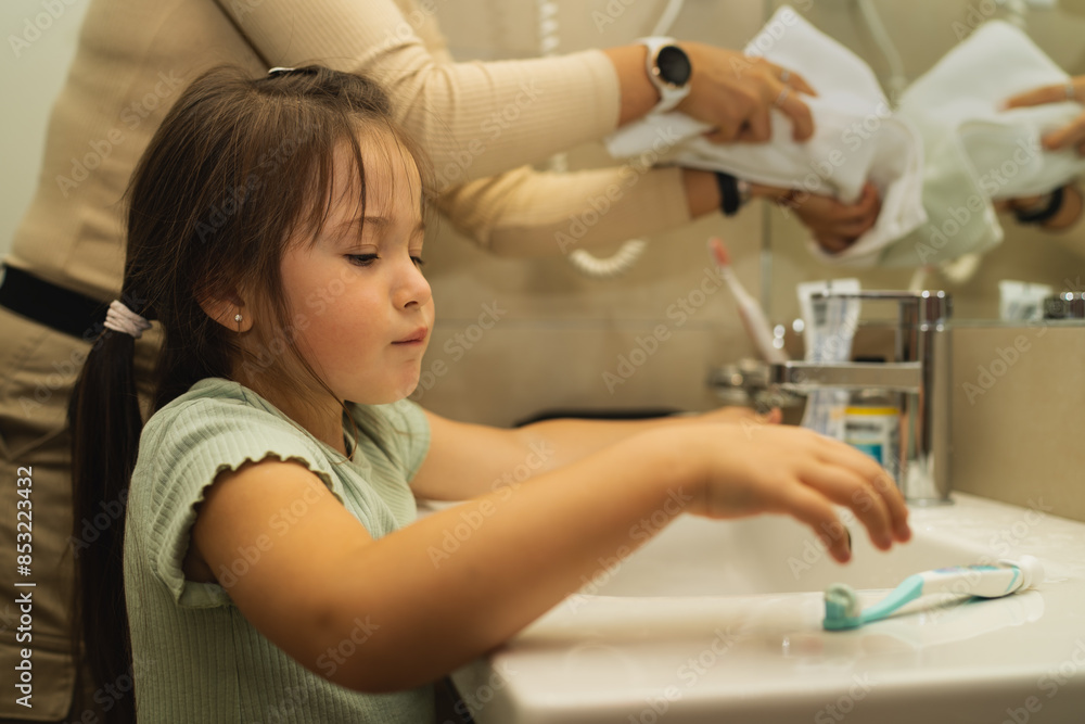 A little 6 year old girl is going to brush her teeth in the bathroom in the morning. A little 6 year old girl is going to brush her teeth in the bathroom in the morning.
