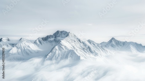 Wallpaper Mural Snow-capped mountain peaks rise above a sea of clouds, creating a serene and majestic winter landscape. The sharp ridges and white snow contrast against the soft, misty clouds. Torontodigital.ca