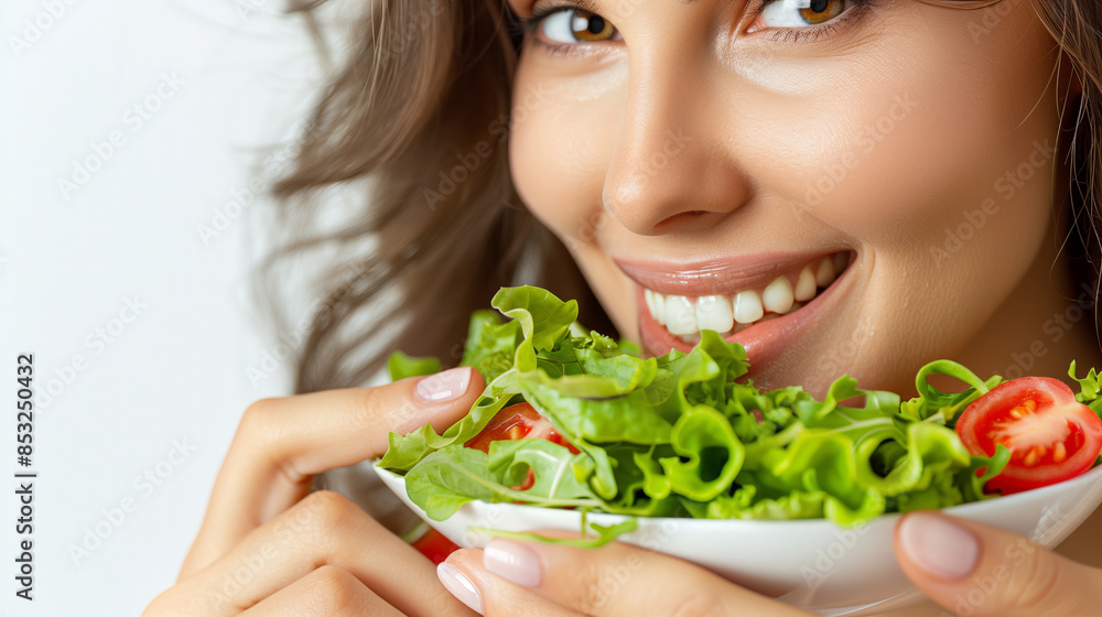 Smiling woman enjoys a healthy meal of lettuce and tomatoes, vegetarian nutrition concept Smiling woman enjoys a healthy meal of lettuce and tomatoes, vegetarian nutrition concept