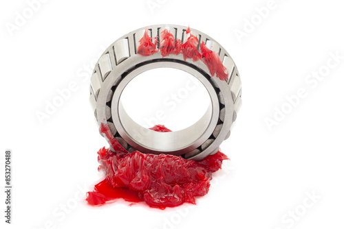 A tapered roller bearing with red lithium grease (Machinery Lubrication). Isolated on a white background. Front view. photo