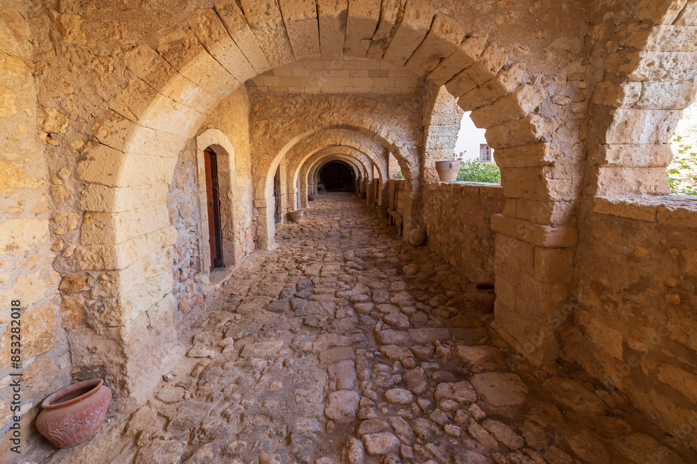 Europe, Greece, Crete, Rethymno. Venetian Baroque, 16th C. Eastern Orthodox Monastery. The Holy Monastery of Arkadi. Arched stone passageway. Europe, Greece, Crete, Rethymno. Venetian Baroque, 16th C. Eastern Orthodox Monastery. The Holy Monastery of Arkadi. Arched stone passageway.