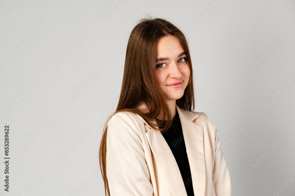Young Woman in White Jacket and Black Pants on Gray Background. Young Woman in White Jacket and Black Pants on Gray Background.