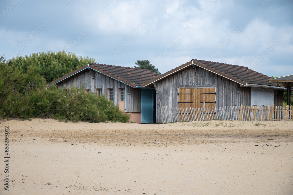 Old wooden huts and oysters farms in Port de la Hume, Gujan-Mestras village, cultivation and sale of fresh oysters seashells, Arcachon bay, Atlantic ocean, France, tourists destination Old wooden huts and oysters farms in Port de la Hume, Gujan-Mestras village, cultivation and sale of fresh oysters seashells, Arcachon bay, Atlantic ocean, France, tourists destination