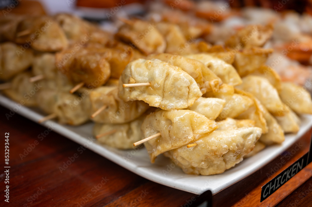 Typical snack of Basque Country, pinchos or pinxtos skewers with small pieces of bread, sea food, eggs, cheese, jamon served in bar in San-Sebastian or Bilbao, Spain, close up Typical snack of Basque Country, pinchos or pinxtos skewers with small pieces of bread, sea food, eggs, cheese, jamon served in bar in San-Sebastian or Bilbao, Spain, close up