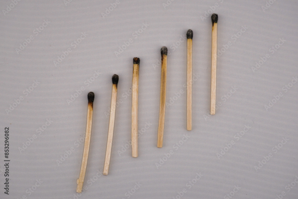 This is a close up picture of matches that have been burned, lined up in a row, to create and interesting pattern and background. This is a close up picture of matches that have been burned, lined up in a row, to create and interesting pattern and background.