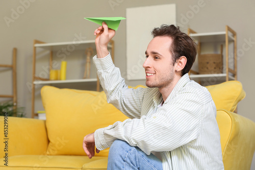 Young man throwing paper pl...