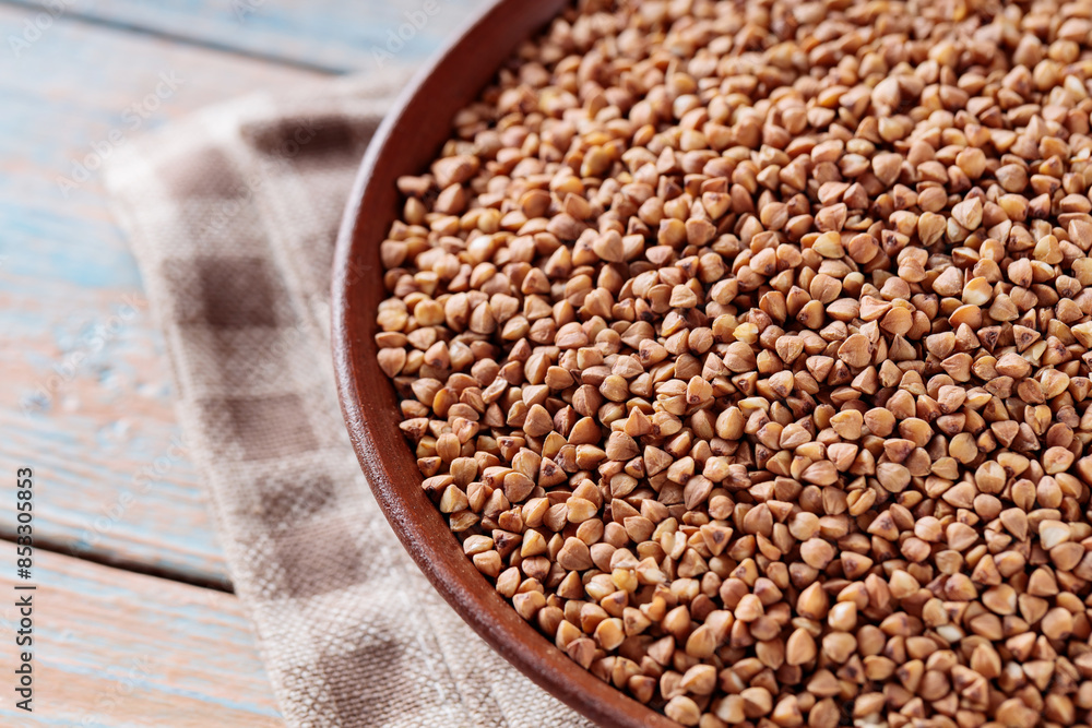 Raw Buckwheat Grains in Clay Bowl, Close Up Raw Buckwheat Grains in Clay Bowl, Close Up