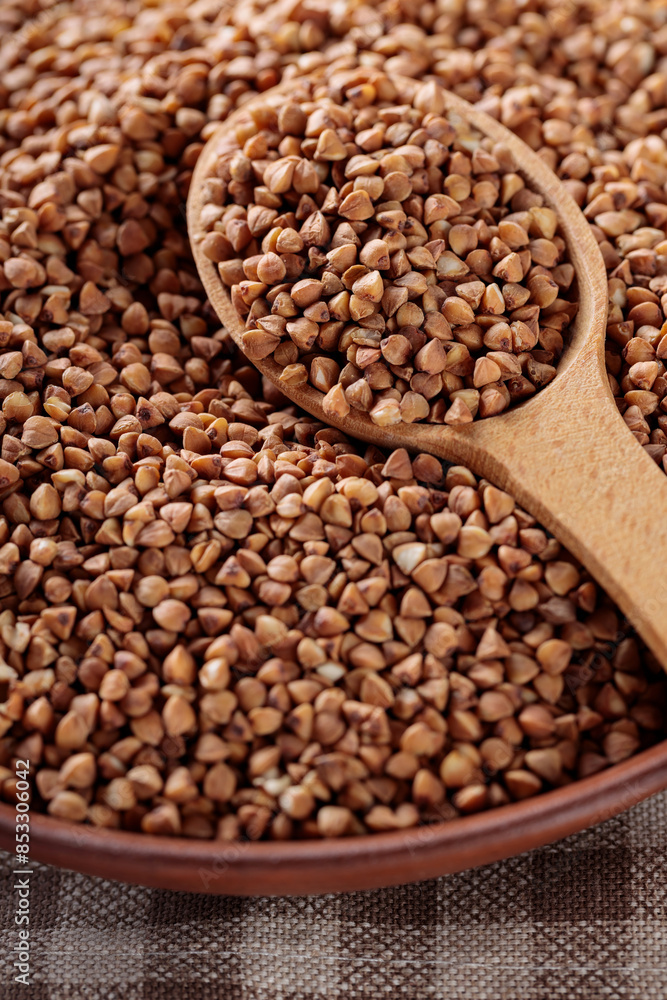 Raw Buckwheat Grains in Clay Bowl, Close Up Raw Buckwheat Grains in Clay Bowl, Close Up
